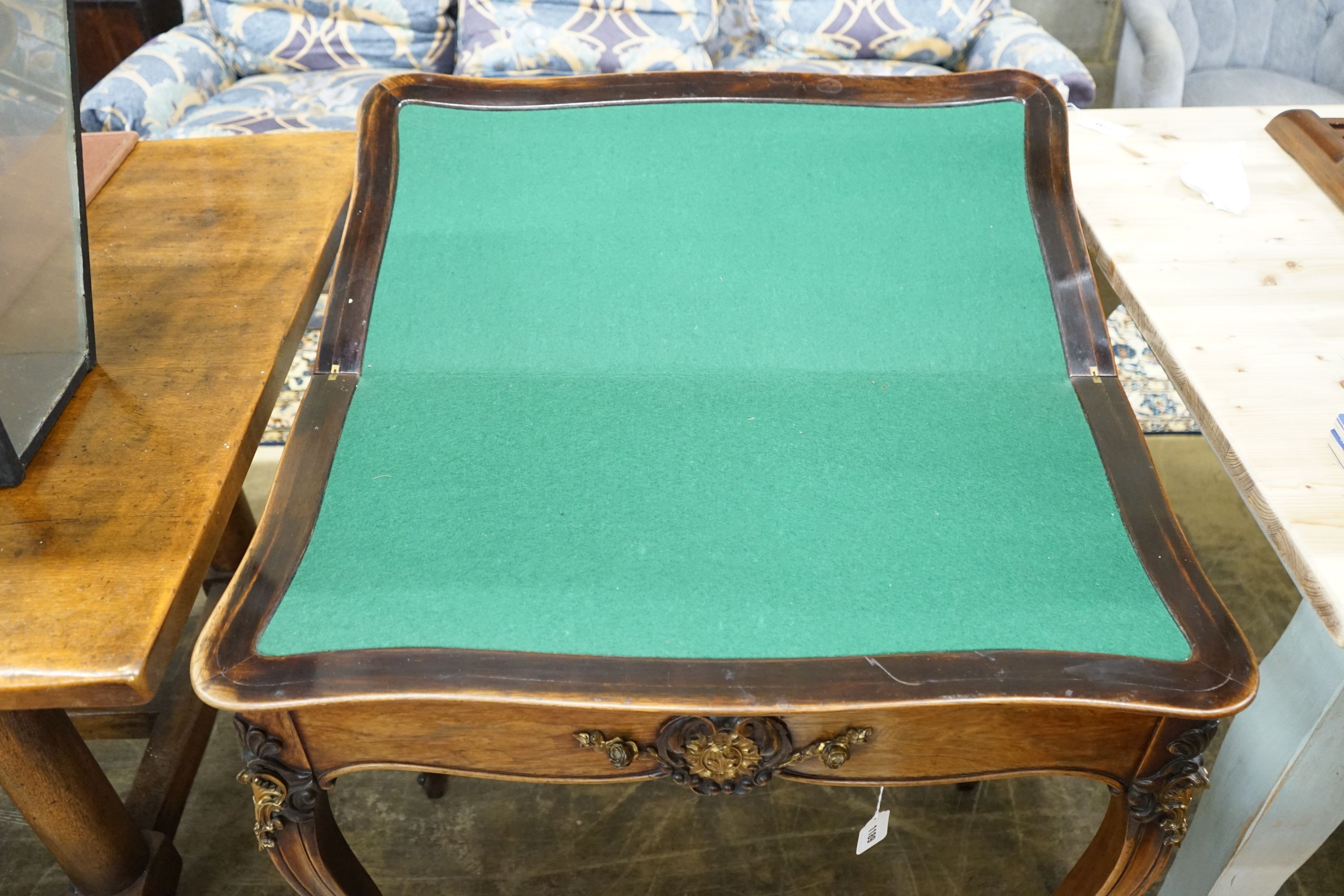 A 19th century French gilt metal mounted rosewood serpentine folding card table, width 82cm, depth 41cm, height 76cm